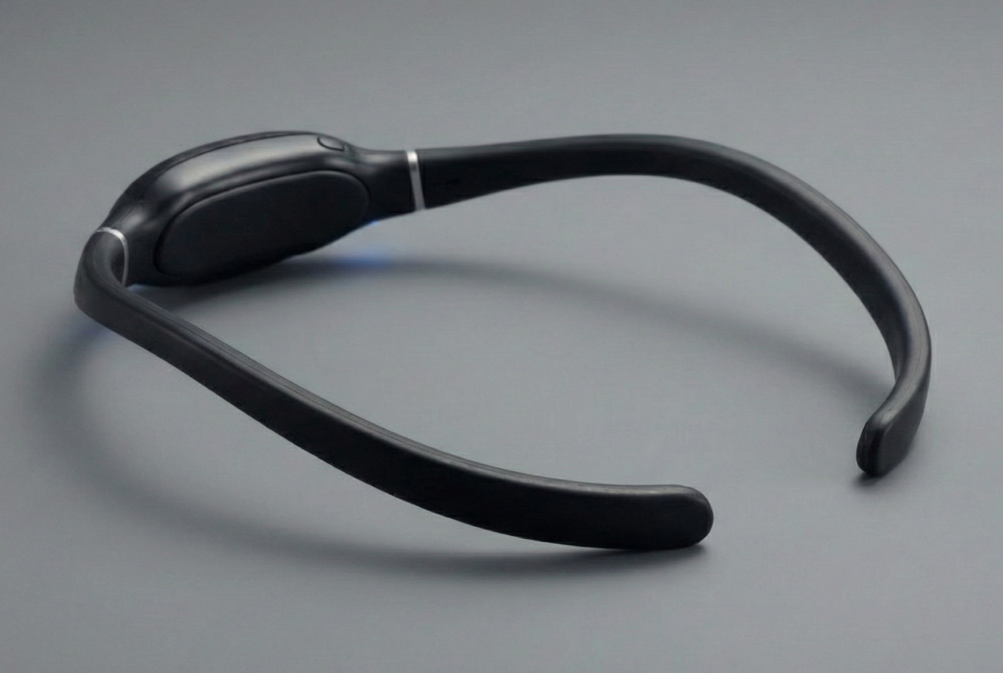Black neckband device on a gray background